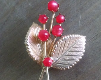 Vintage gold pin with red accents