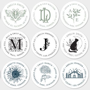 May include: A collection of fifteen circular address labels featuring various black and green ink illustrations, including a bee, a lighthouse, a cat, a sunflower, a house, and monogrammed initials, all surrounded by circular text with names and addresses.