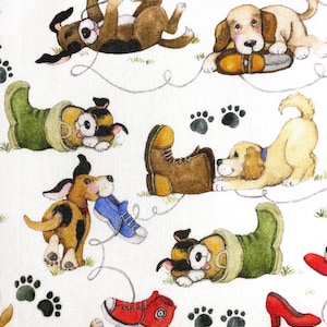 May include: White fabric with a repeating pattern of playful dogs, shoes, and paw prints. The dogs are depicted in various poses, interacting with red, blue, and brown shoes. Green grass and red high heels are also present.