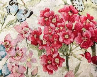 May include: A floral fabric with a cream background featuring pink, red, and white flowers and butterflies. The butterflies are in various shades of blue, brown, and pink.