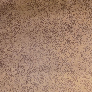 May include: A tan fabric featuring a repeating pattern of dark brown botanical sprigs with small leaves and berries. The textile has a visible woven texture, and the print consists of thin, dark brown lines that create a dense, uniform design across the surface.