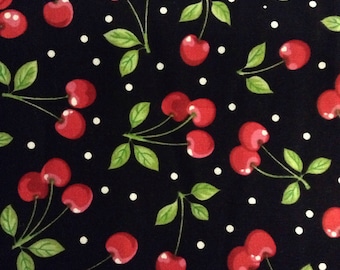 May include: A fabric pattern featuring bright red cherries with green leaves and stems against a black background. White polka dots are scattered throughout the design. The cherries are in various clusters.
