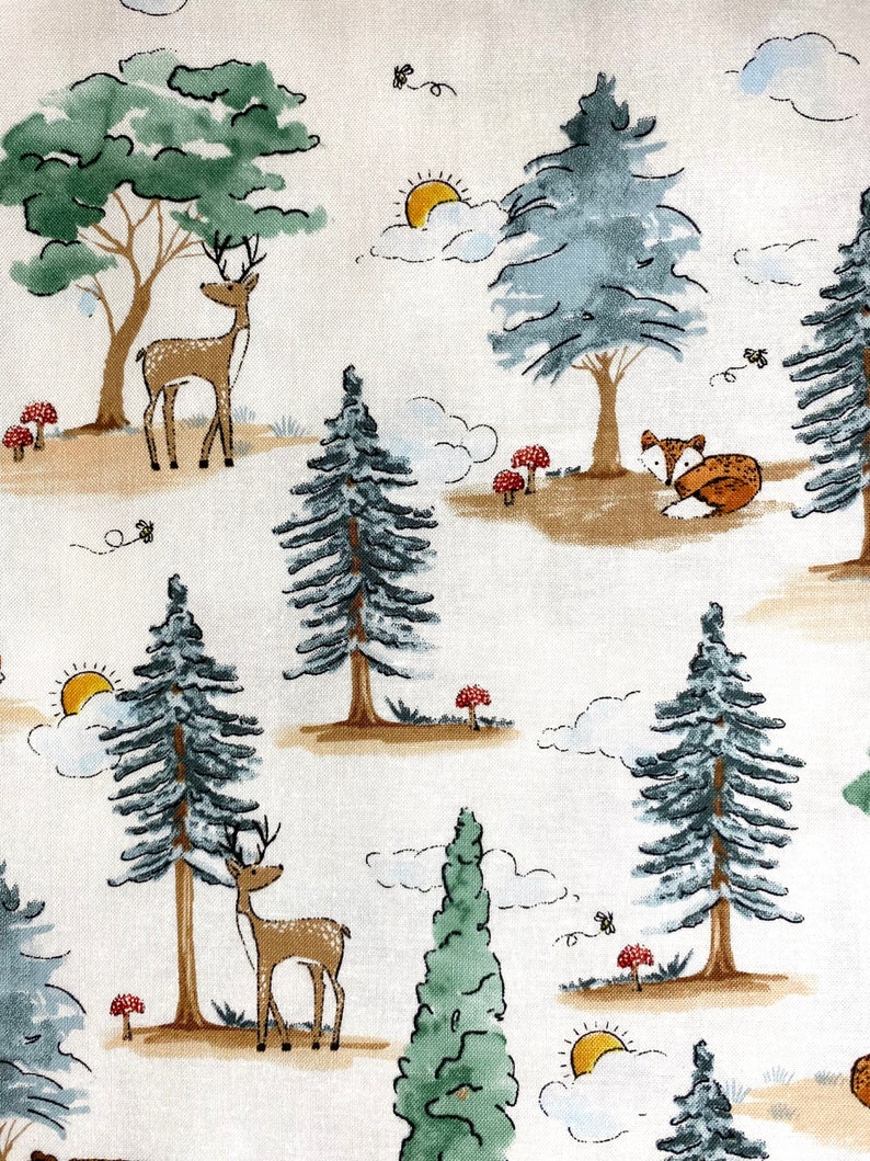 May include: A white fabric with a repeating pattern of stylized trees, deer, and foxes. The trees are green and blue, the deer are brown, and the foxes are orange. There are also small red mushrooms and yellow suns in the pattern.