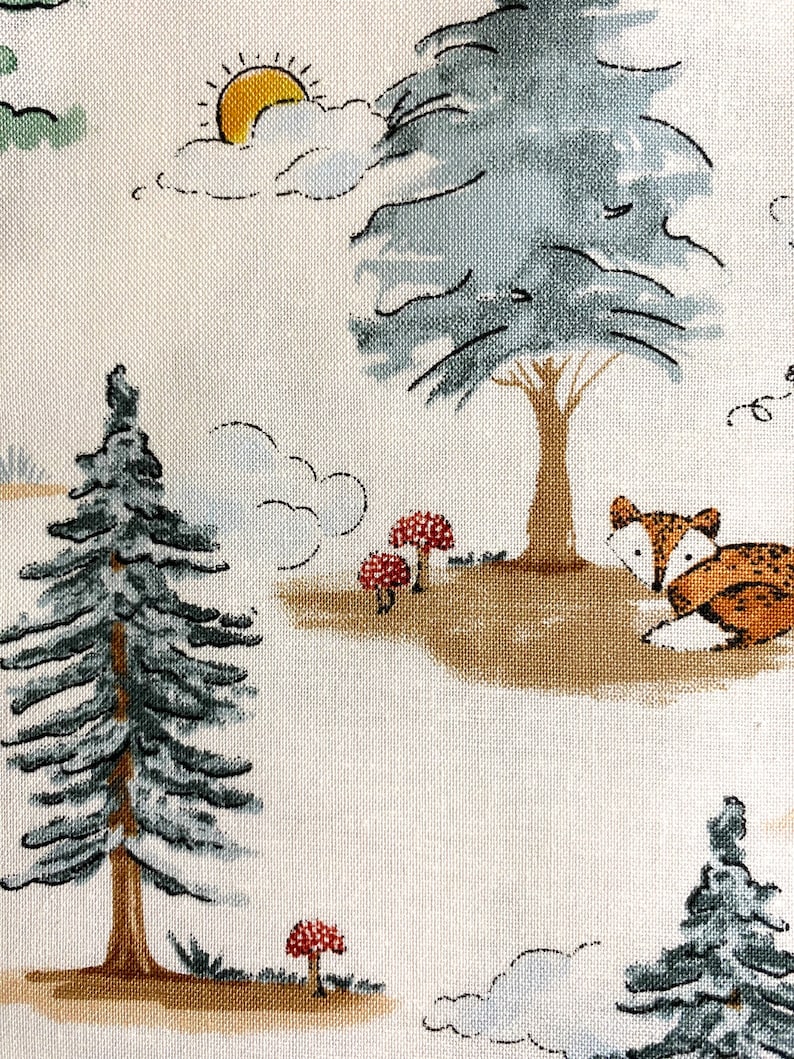 May include: A white fabric with a repeating pattern of a green pine tree, a blue tree, a yellow sun, white clouds, and a brown fox with red mushrooms.