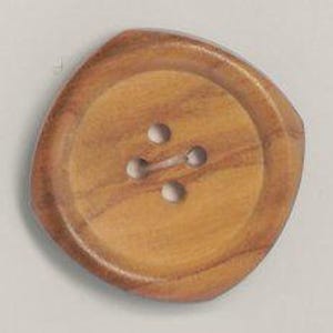 May include: A large, round wooden button with four holes. The button has a natural wood grain pattern and a slightly irregular, square shape. The button is a light brown color.