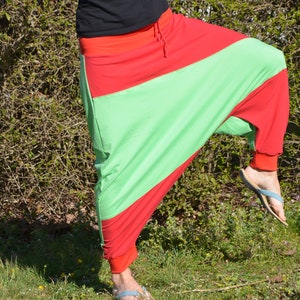 May include: A pair of red and green pants with a loose, flowing fit. The pants are made of a soft, comfortable fabric and have a unique, stylish design.