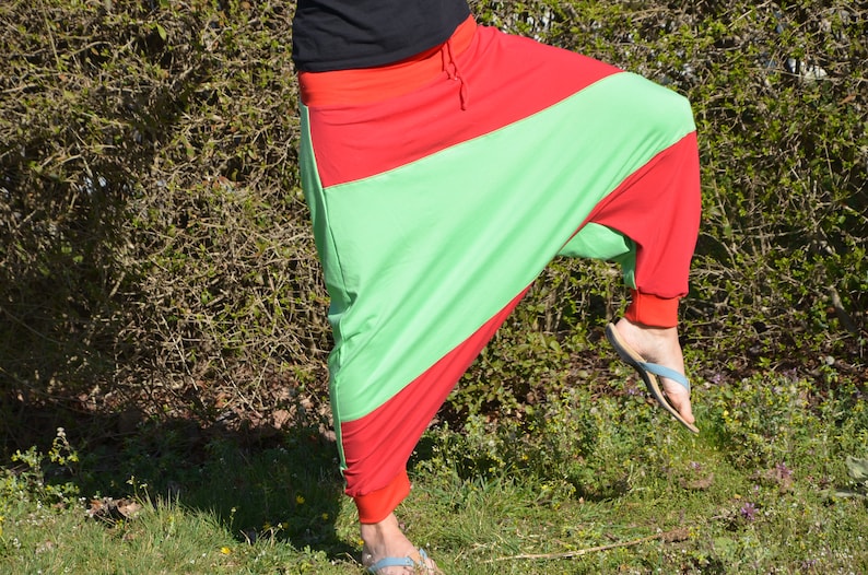 May include: A pair of red and green pants with a loose, flowing fit. The pants are made of a soft, comfortable fabric and have a unique, stylish design.