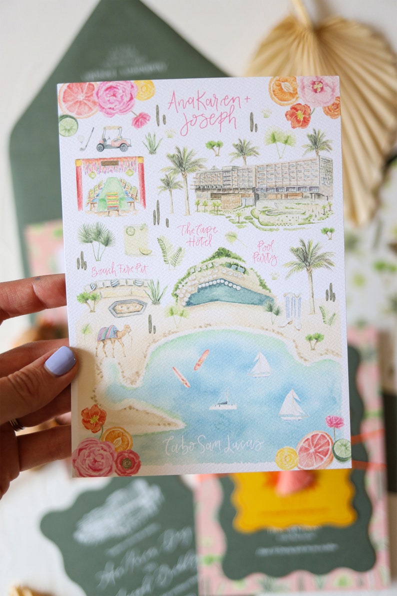 May include: A watercolor illustration of a wedding invitation with a map of Cabo San Lucas, Mexico. The map features a hotel, a pool party, a beach fire pit, and a golf cart. The text "Ana Karen + Joseph" is written at the top of the map.