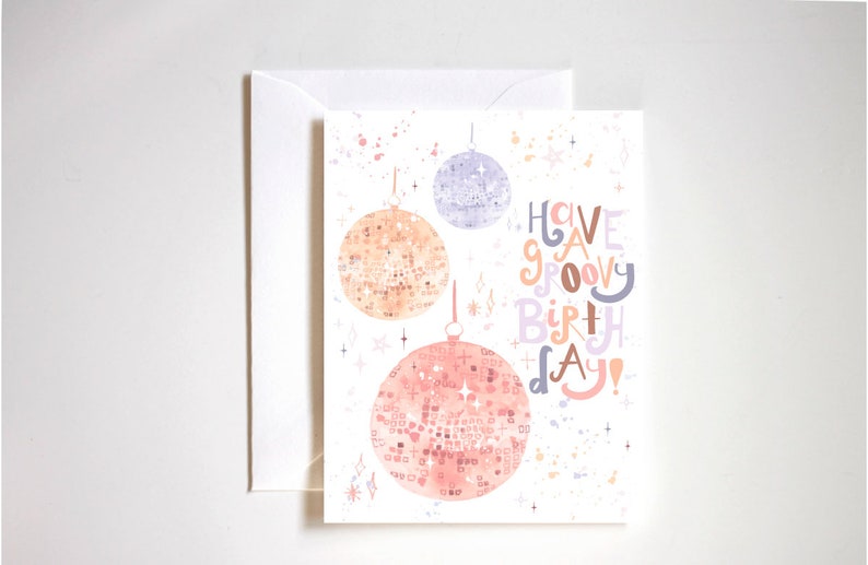 May include: A white card with a colorful illustration of disco balls and the text "Have a groovy birthday!"