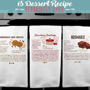 May include: Three white kitchen towels with embroidered dessert recipes: Chocolate Chip Cookies, Strawberry Shortcake, and Brownies. Each towel features a small illustration of the dessert.