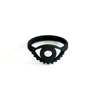 Bold graphic 3d printed black goth ring with evil eye design, displayed on white background