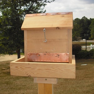 Squirrel feeder made from Western Red Cedar with post mount attached, accomodates peanuts and/or seed