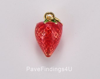 May include: A red strawberry charm with a gold-colored bail and green leaves. The charm has a textured surface and is likely made of enamel. The charm is a jewelry finding.