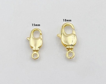 May include: Two gold-toned lobster claw clasps, one measuring 15 mm and the other 18 mm.