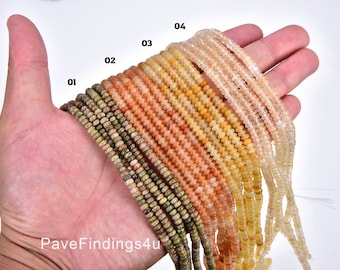 May include: A variety of 10 strands of faceted gemstone beads in shades of green, peach, orange, and yellow. The beads are approximately 4mm in diameter and are strung on a thin wire.