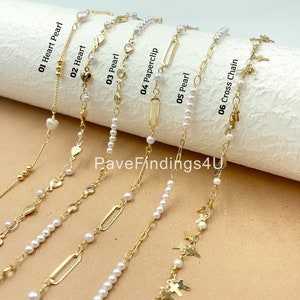 May include: A set of ten gold chain necklaces with pearl accents. The chains feature different charms, including hearts, paperclips, and crosses.