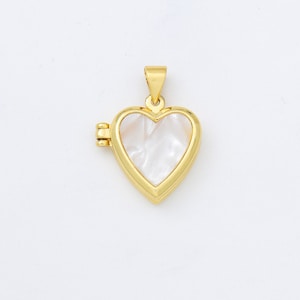 May include: Gold heart-shaped locket with a white mother-of-pearl inlay. The locket opens with a hinge on the side.