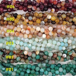 May include: Six rows of agate beads in various colors, including green, brown, blue, and red. Each row is labeled with a number from 1 to 6.