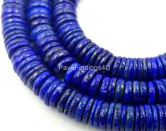 May include: A strand of deep blue lapis lazuli beads with gold flecks. The beads are round and flat, and they are strung together in a continuous loop. The beads are approximately 10mm in diameter.
