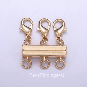 May include: Gold-toned metal clasp with three lobster claw clasps and three jump rings.  PaveFindings4U is printed below the clasp.