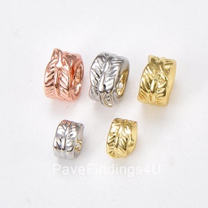 May include: Four metal bead spacers with a leaf design. The spacers are in silver, gold, and rose gold.