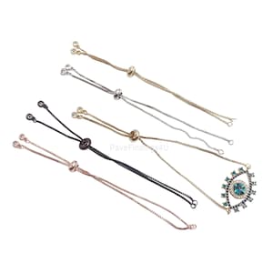 May include: Five adjustable bracelet cords with different colored metal beads and clasps. One bracelet has a large blue and green evil eye charm.