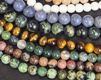 May include: A collection of colourful gemstone beads, including green, blue, brown, and white. The beads are arranged in rows, with the largest beads at the bottom and the smallest beads at the top.