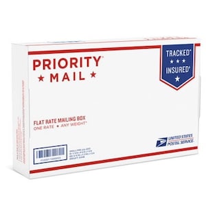 May include: A white Priority Mail flat rate mailing box with the text "TRACKED" and "INSURED" in black. The box is labeled "FLAT RATE MAILING BOX" and "ONE RATE ANY WEIGHT".