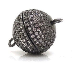 May include: Black metal ball clasp with a pave setting of small clear rhinestones. The clasp is designed to be used as a necklace or bracelet closure.