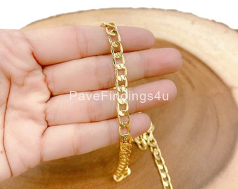 May include: Gold curb chain necklace with a flat, slightly rounded design. The chain is shown in a hand, with the text "PaveFindings4u" visible in the image.