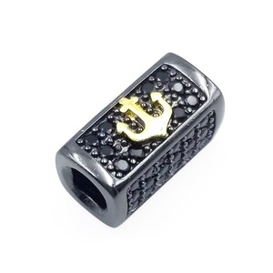May include: Black metal bead with a gold anchor charm and black cubic zirconia stones.