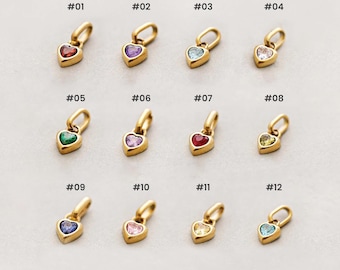 May include: A collection of twelve heart-shaped pendants with gold-colored settings and various colored gemstones. Each pendant is numbered from #01 to #12, with gemstones in red, purple, blue, clear, green, pink, and yellow.