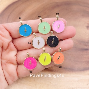 May include: Eight gold charms with different colored enamel and a lightning bolt design. The charms are numbered 01 through 08.