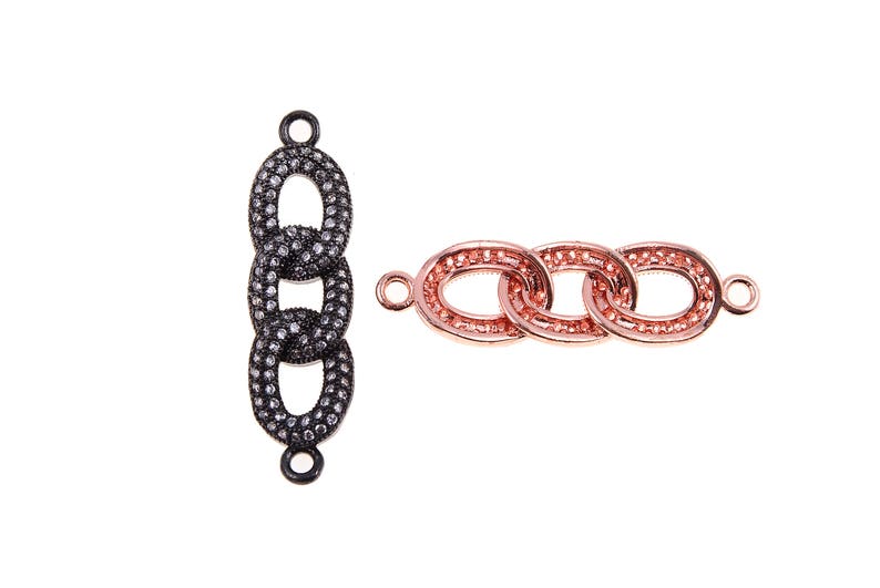 May include: Two jewelry components. One is a vertical chain of three oval links in black with small, sparkling accents. The other is a horizontal chain of three oval links in rose gold, also with sparkling accents. Both have small loops for attachment.