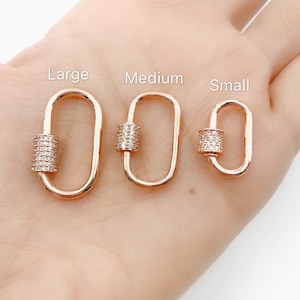 May include: Three gold-toned lobster clasps with clear cubic zirconia stones. The clasps are labeled "Large", "Medium", and "Small" from left to right.