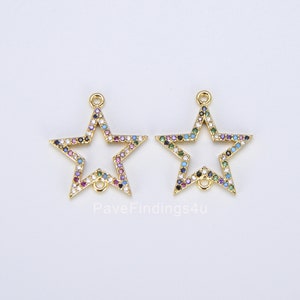 May include: Two gold-colored star-shaped charms with colorful gemstones. Each charm has a loop at the top and bottom for attaching to jewelry. The gemstones are in various colors, including blue, green, purple, and pink.