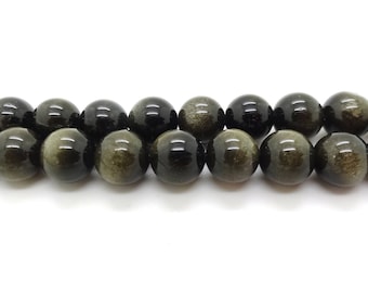 May include: A strand of round, black and gold gemstone beads. The beads have a shimmering, iridescent effect.