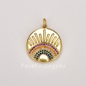 May include: Gold-toned pendant featuring a rainbow design with colorful cubic zirconia stones. The pendant has a sunburst design with a small sun in the center.
