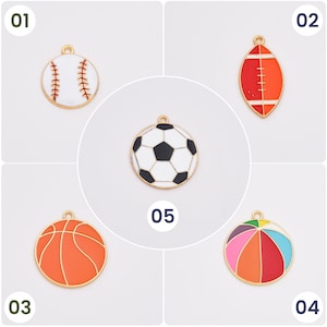 May include: Five different sports ball charms, each with a gold loop for hanging. The charms are a baseball, soccer ball, basketball, beach ball, and football. The charms are all white with black and red details.