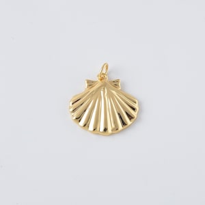 May include: A gold-colored seashell pendant with a loop at the top for a chain. The pendant has a detailed, ridged design and a smooth, polished finish. The seashell is a classic nautical charm.