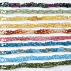 May include: A collection of ten strands of faceted gemstone beads in various colors. The strands are labeled with numbers from #01 to #10. Colors include green, purple, yellow, orange, pink, blue, and green.