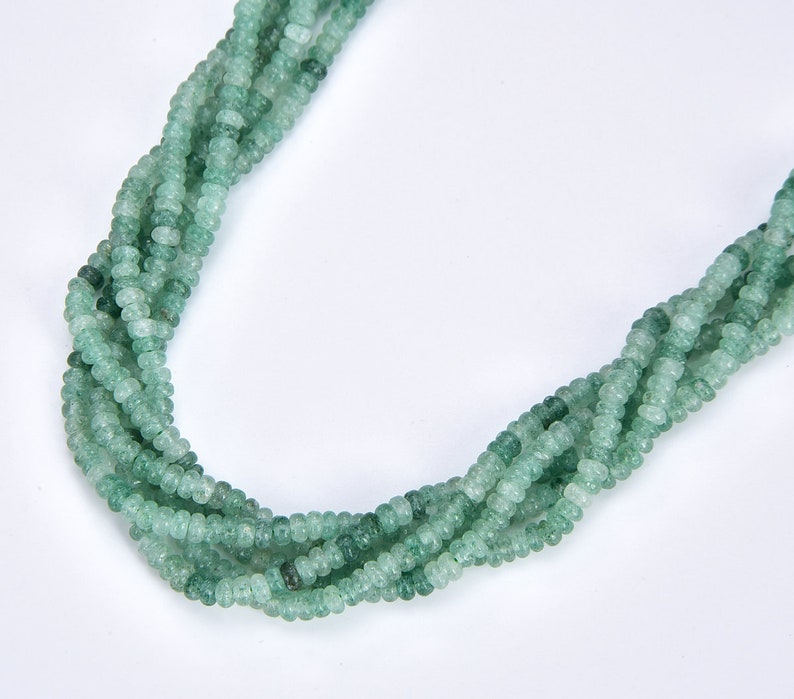 May include: A strand of green gemstone beads, with a frosted finish, strung together to form a necklace.