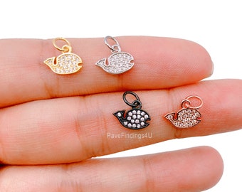 May include: Four whale charm pendants with clear crystal accents. The charms are in gold, silver, black, and rose gold.
