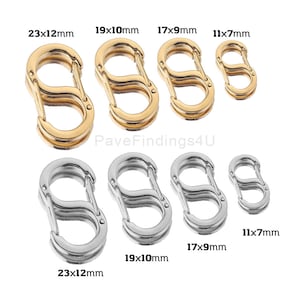 May include: A collection of gold and silver-colored S-shaped clasps in various sizes. The clasps are displayed on a white background, with size measurements in millimeters. The text "PaveFindings4U" is visible in the image.