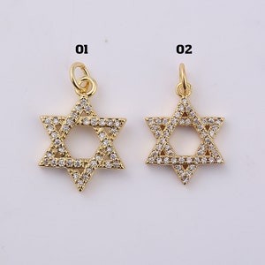 May include: Two gold pendants in the shape of a Star of David, each with clear cubic zirconia stones. The pendants are labeled "01" and "02".