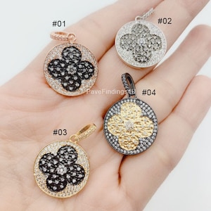 May include: Four different styles of clover-shaped pendants with black and white pave crystals. The pendants are made of silver, gold, and rose gold. #01 is rose gold, #02 is silver, #03 is gold, and #04 is black.