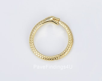 May include: Gold ring with a snake design. The snake is biting its tail, forming a circle. The snake is textured and has a hand design on the top.