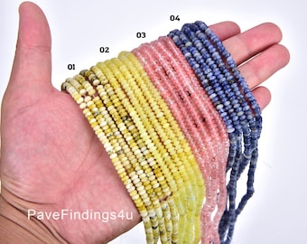 May include: Four strands of beads in different colors. The first strand is yellow with brown speckles, the second is light yellow, the third is light pink, and the fourth is blue. The strands are labeled with numbers 1 through 4.