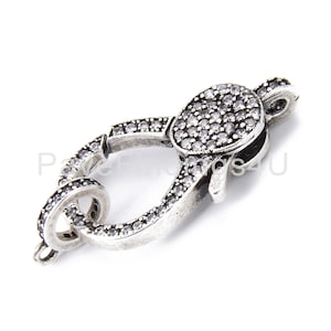 May include: Silver-toned clasp with clear crystal embellishments. The clasp is designed to be used for jewelry making.