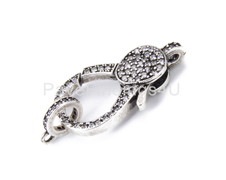 May include: Silver-toned clasp with clear crystal embellishments. The clasp is designed to be used for jewelry making.